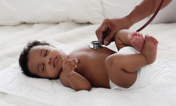 african american baby girl being health checkup with stethoscope