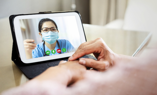 Asian doctor woman talking with Senior Female patient on digital tablet, telemedicine
