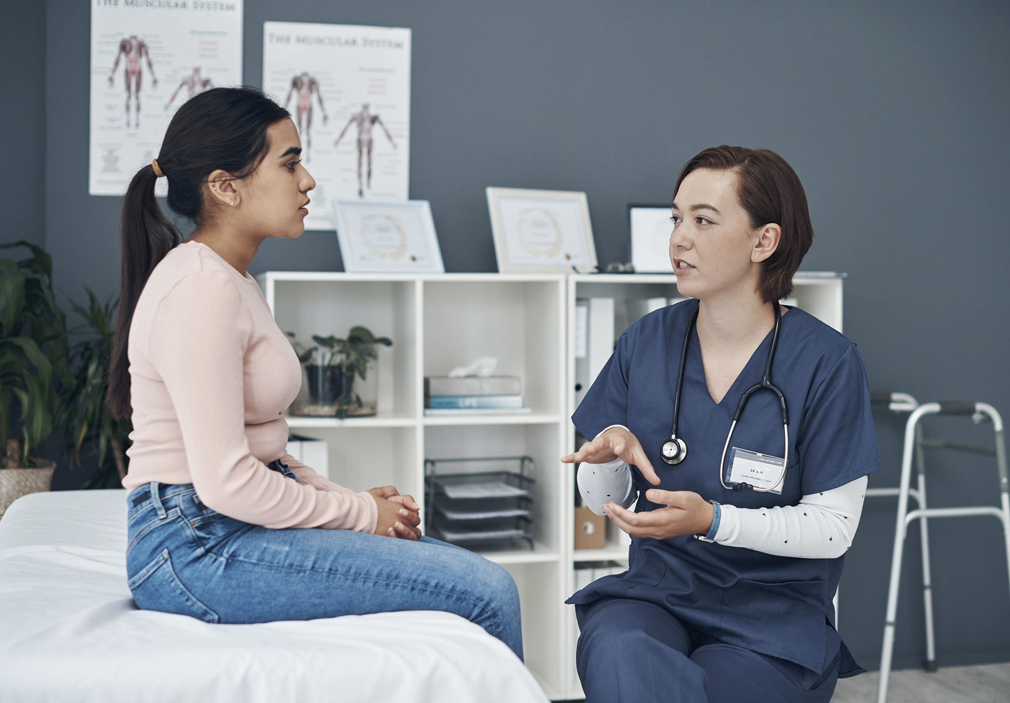 Shot of a young female doctor talking to a patient in an office