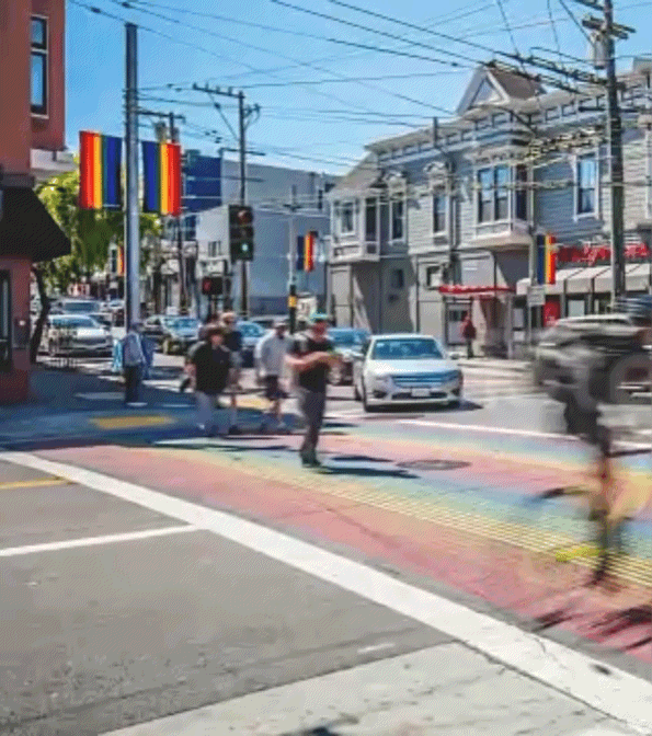 Gif of a crosswalk painted rainbow for Pride