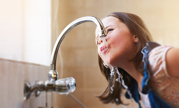 Girl drinking from tap