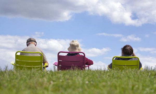 Family enjoying recreation - relaxing in the park against a clear blue sky.