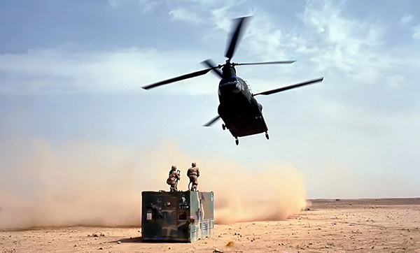 Chinook helicopter flying in for load in desert