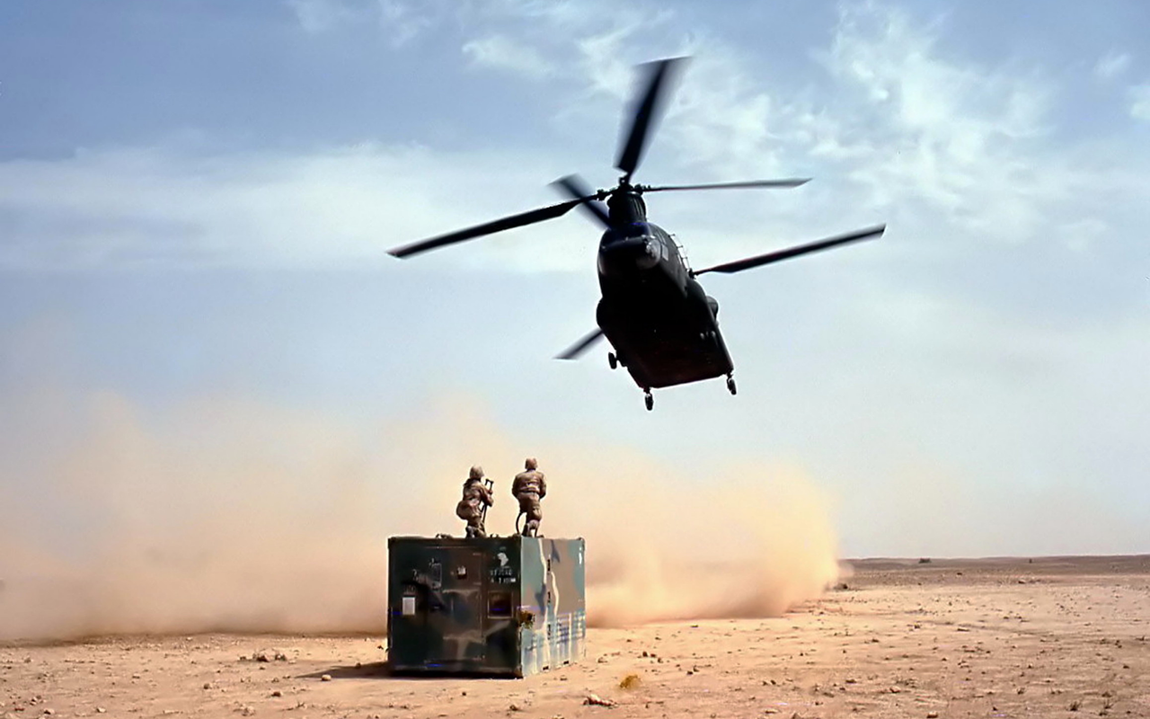 Chinook helicopter flying in for load in desert