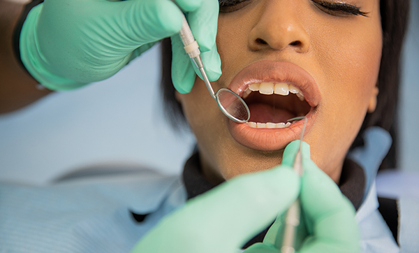 Black woman getting a dental exam