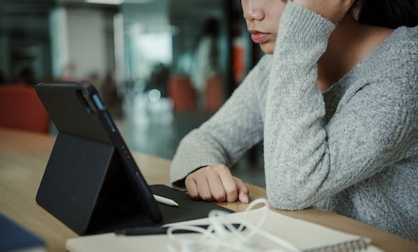 Asian student woman read books in library at university. Young girl stress tired have problem while study hard. Sadness concept