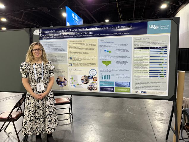 Katie Conklin stands beside her poster at the APHA Annual Meeting.