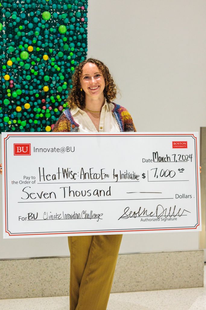 Megan Ryder holds her big cheque.