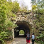 People walk into a tunnel at Franklin Park