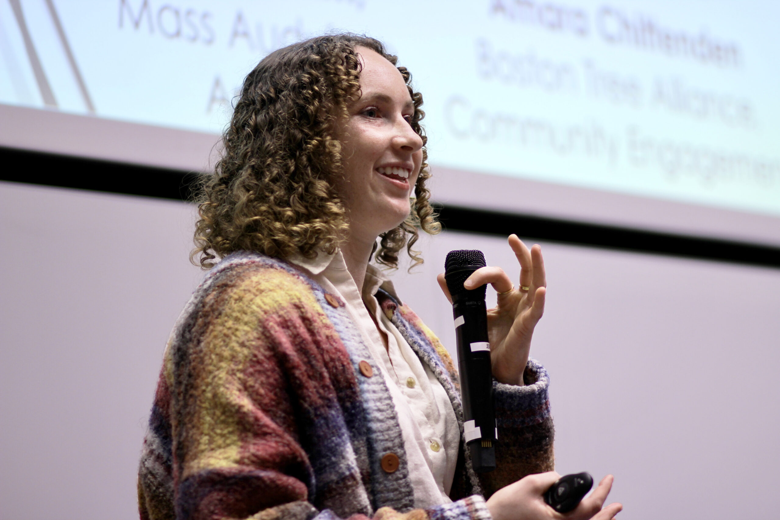 Headshot of Megan Ryder speaking into a microphone