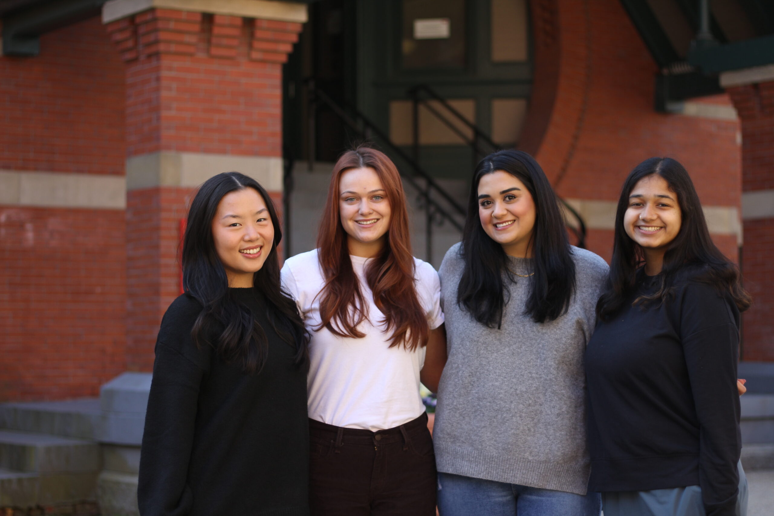 Gwen Ip, Summer Kaeppel, Audeaneh Saberi, and Kavya Ganugapati in front of the Talbot Building.