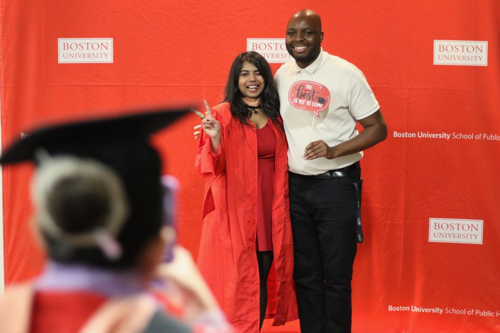 A graduate poses with a member of the SPH staff at the 2024 December Graduate Reception