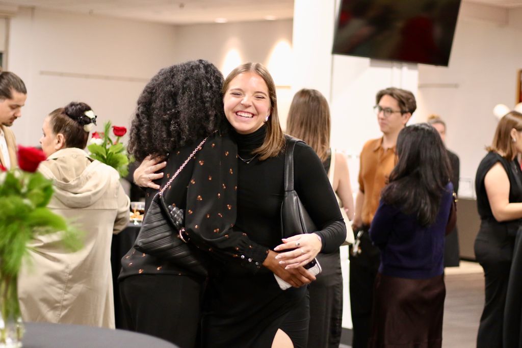 Students embrace at the 2024 December Graduate Reception