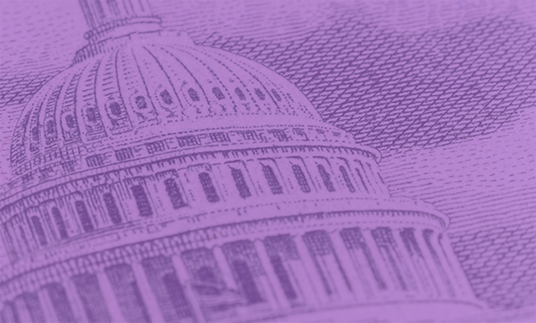A detailed macro photograph of the US Capitol building as depicted on a dollar bill. The intricate engraving highlights the architectural details of the dome, including windows, columns, and bas-reliefs. This image serves as a powerful symbol of American democracy and government.