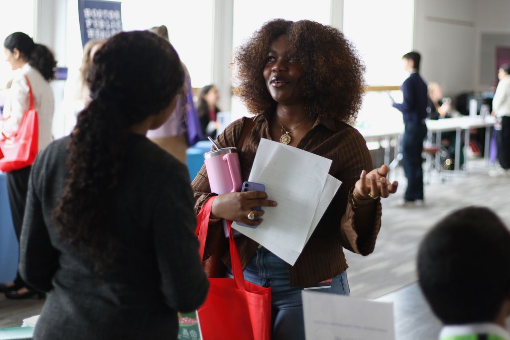 A student speaks with a staff member of a visiting organization during the spring 2025 career fair.