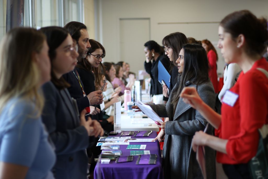 Students speak with staff from visiting organizations at the spring 2025 career fair.