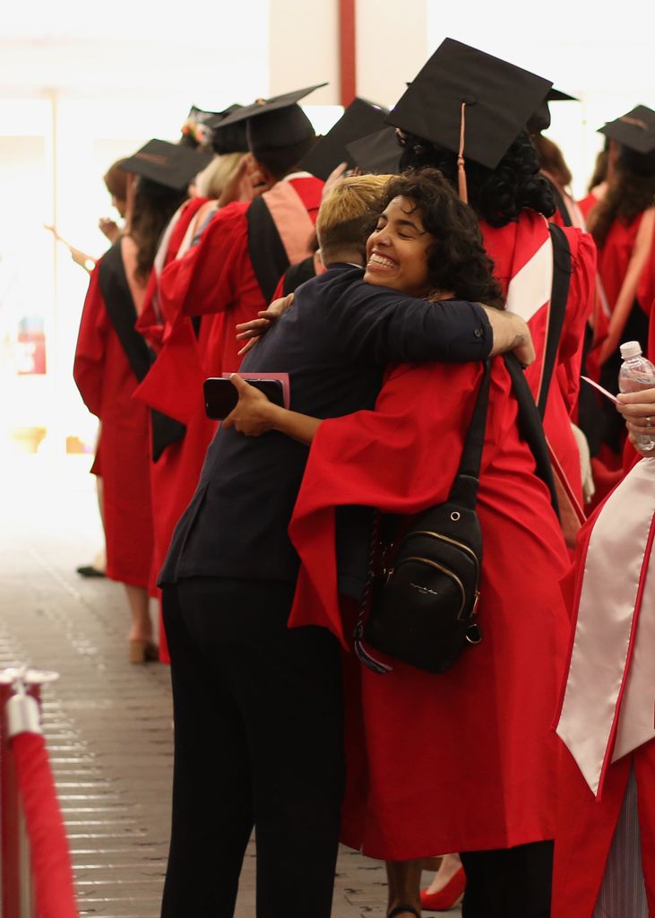 Ryan Wisniewski, staff advisor to SPH's Queer Alliance, and Aisha Ghorashian, former QA administrative officer, share a celebratory hug at convocation.