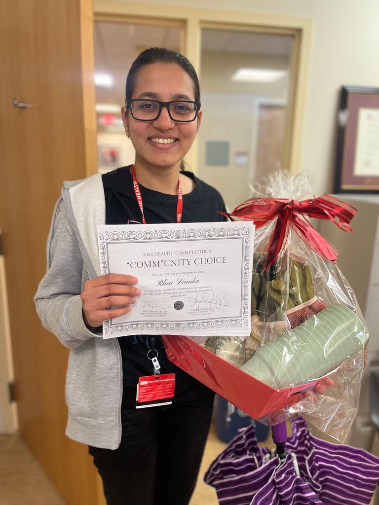 Rhea Dcunha poses with her certificate and prize for winning "Best Photo" in the 2025 Health "Comm"petition