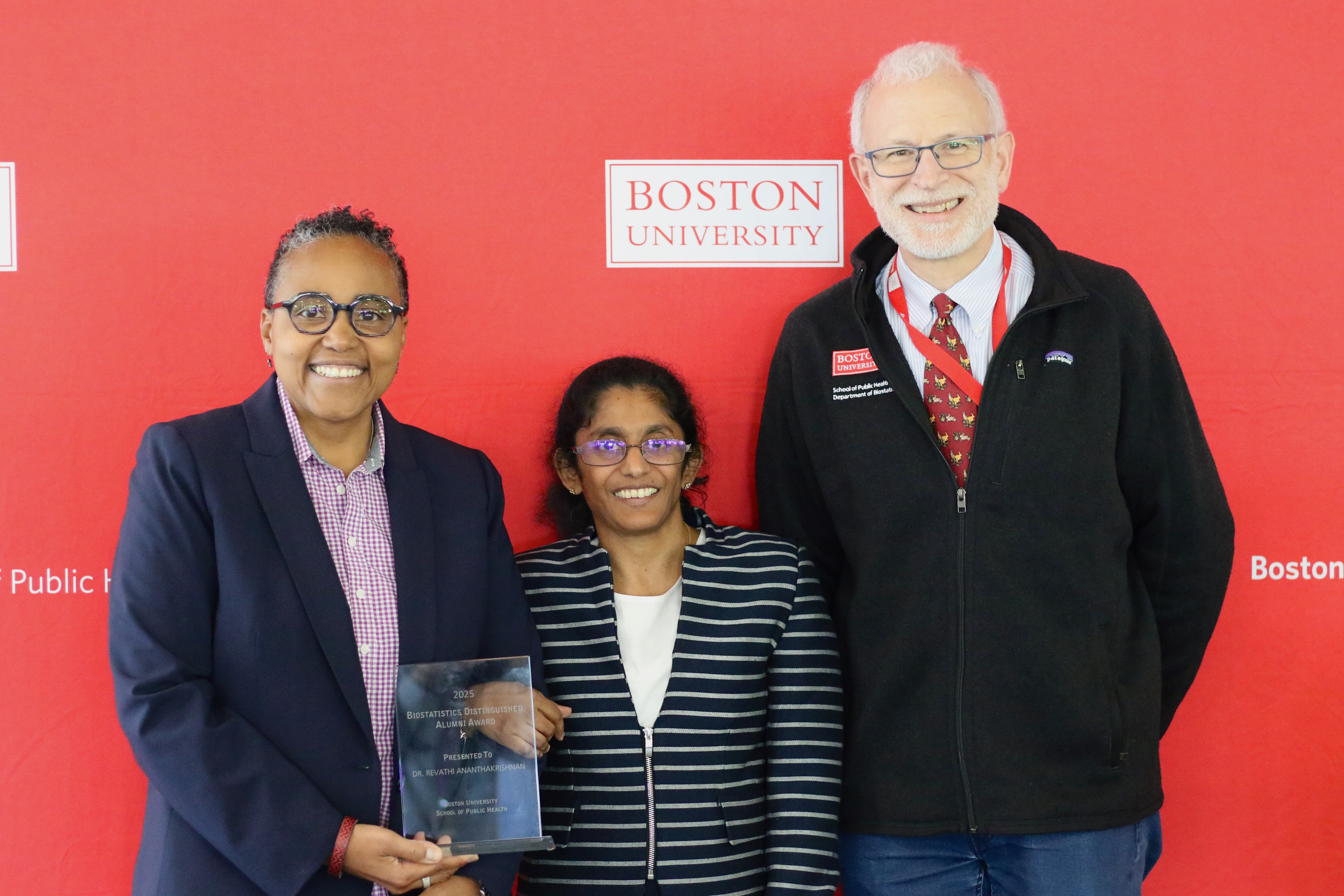 Scarlett Bellamy (left), chair and professor of biostatistics, and Michael Lavalley (right), professor of biostatistics, present Revathi Ananthakrishnan (SPH '17) with the 2025 Biostatistics Distinguished Alumni Award.