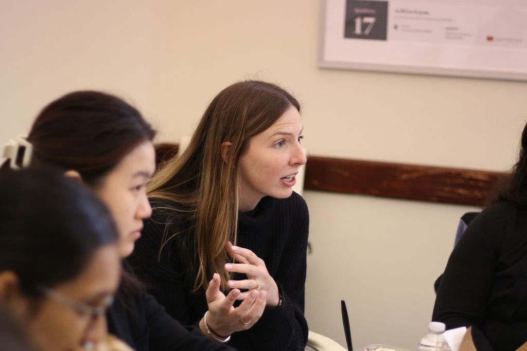 A student asks Marcela del Carmen a question during lunch following her 2025 Donahue Lecture.