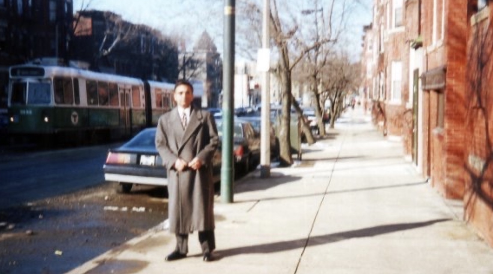 Ghulam Nabi Kazi outside his South Huntington Avenue apartment as a Green Line streetcar goes by in 1997.