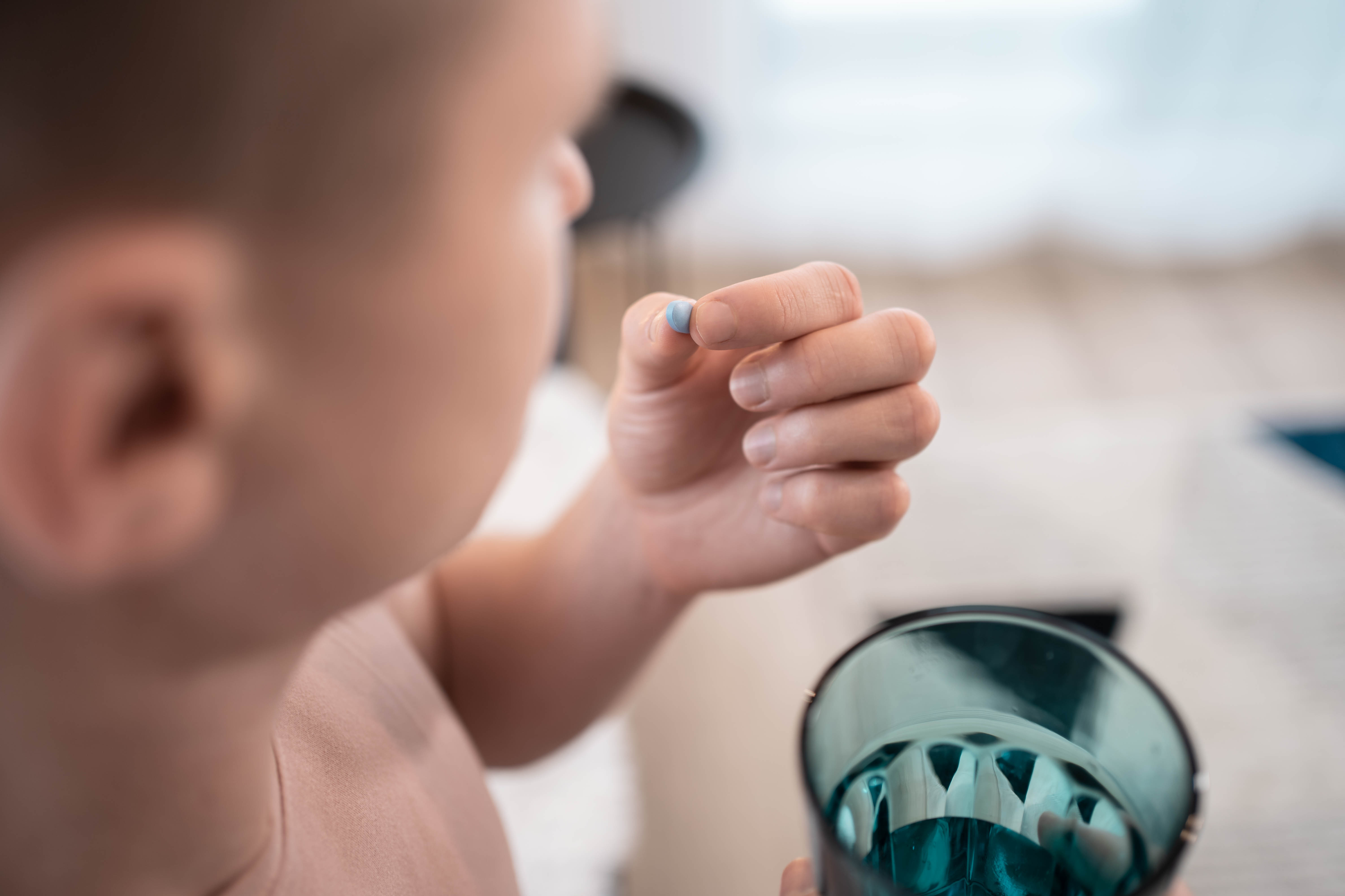 A young man takes a prep in a pill. HIV prevention concept. AIDS prevention concept.