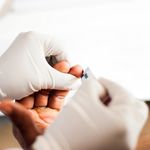above view of bleeding finger after puncture for free hiv test in african hospital