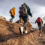 Young hikers with small backpacks walks in mountains