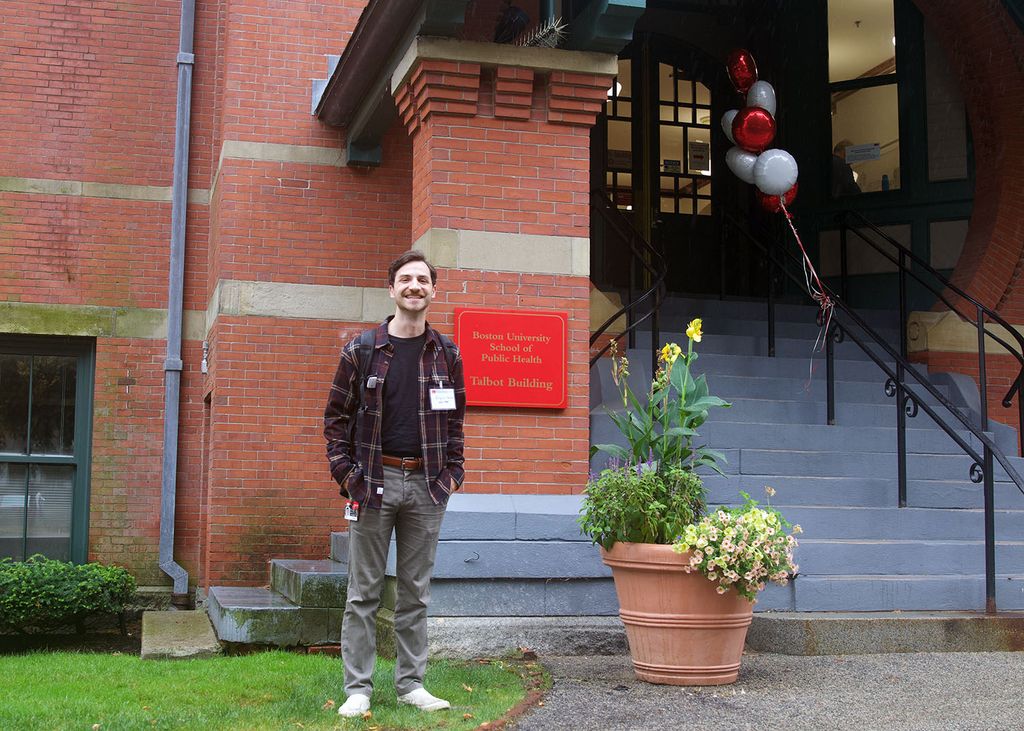 A student poses smiling next to the Talbot Building entrance during fall new student orientation. Photo: Megan Jones