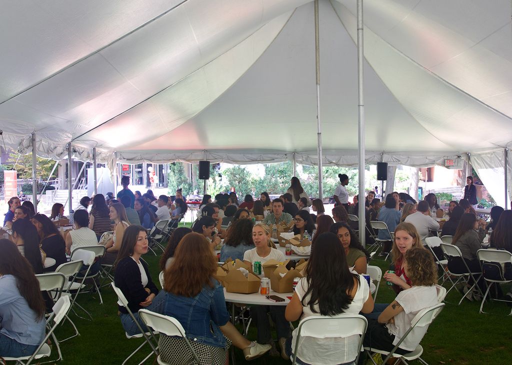Students having lunch under a tent on Talbot Green. Photo: Megan Jones