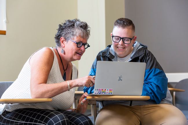 Clinical Associate Professor Hope Haslam Straughan (left) and first-year student Meghan Rondeau meet before class. (Photo by Katherine Taylor)