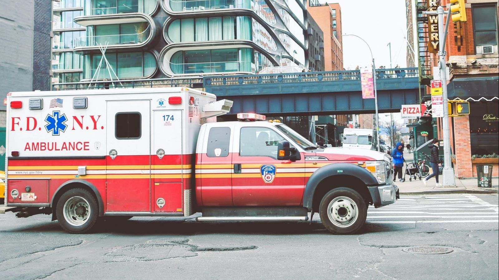 ambulance drives down city street