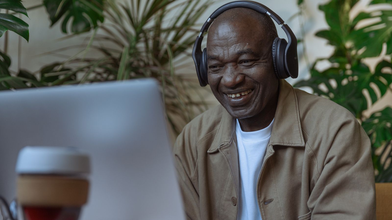 man-wears-headphones-using-computer