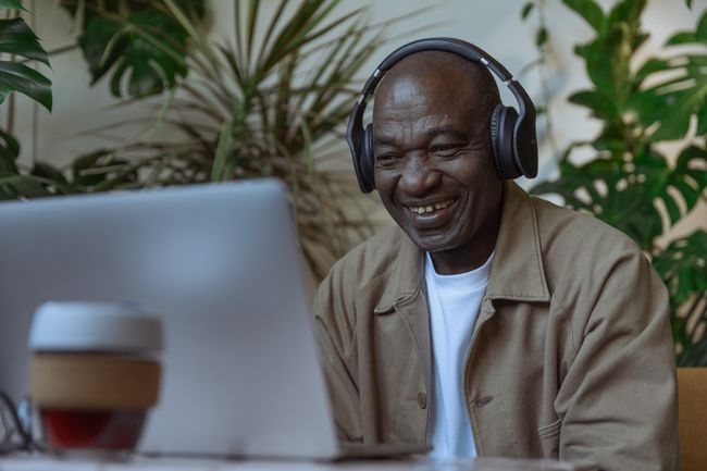man-wears-headphones-using-computer