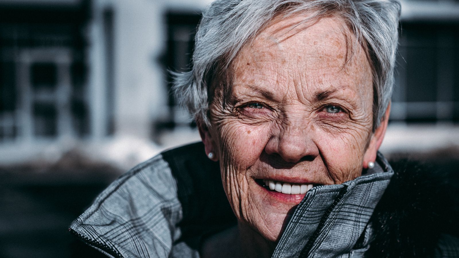 elderly-woman-smiles-at-camera