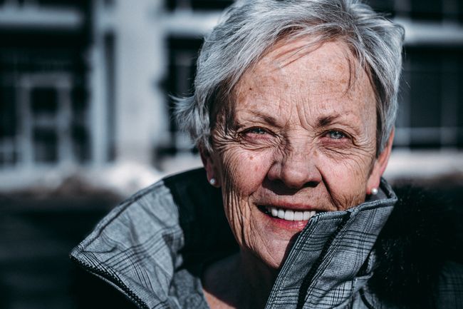 elderly-woman-smiles-at-camera
