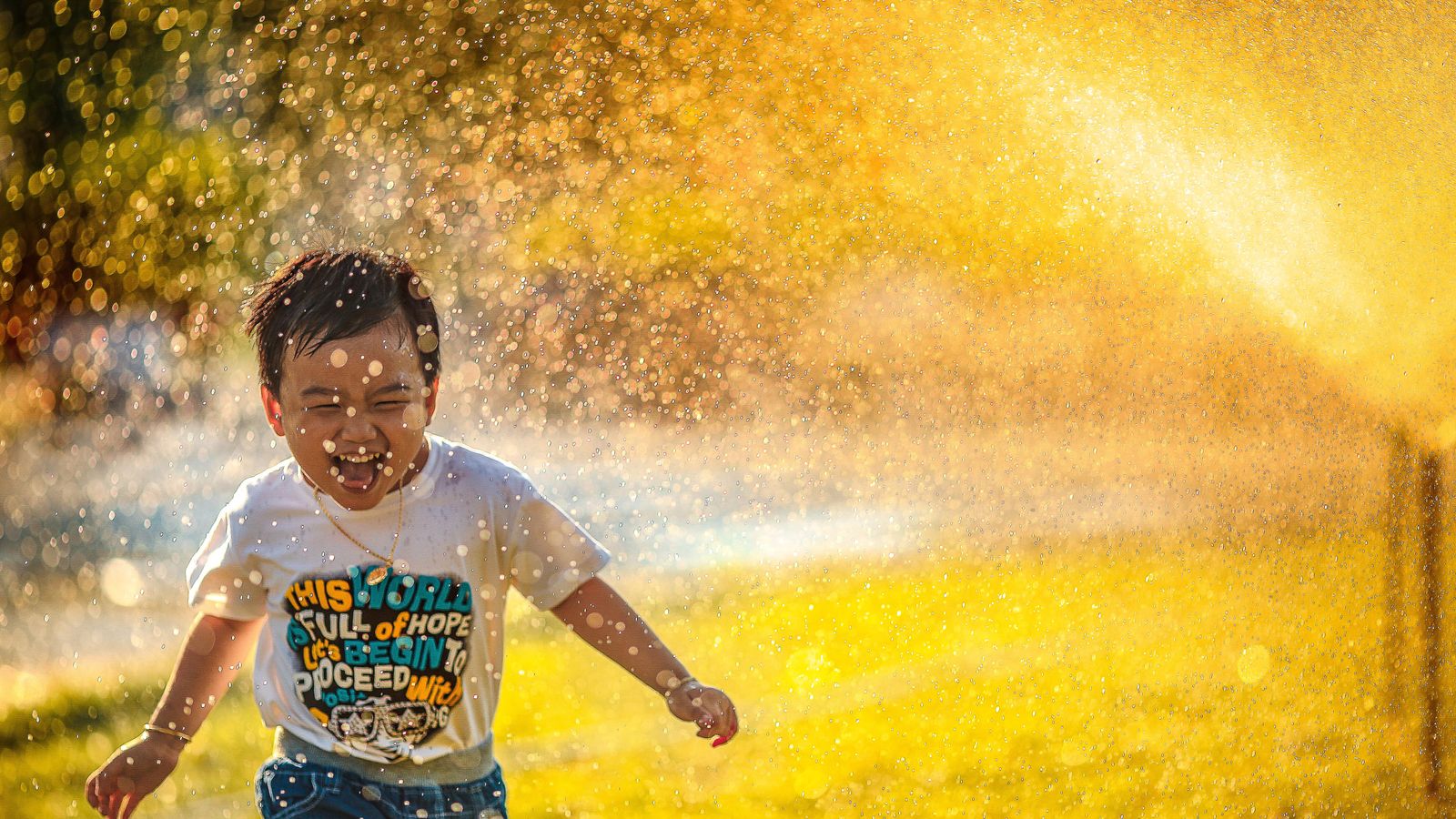 child-runs-through-sprinkler