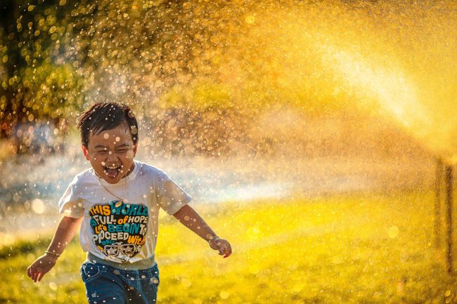 child-runs-through-sprinkler