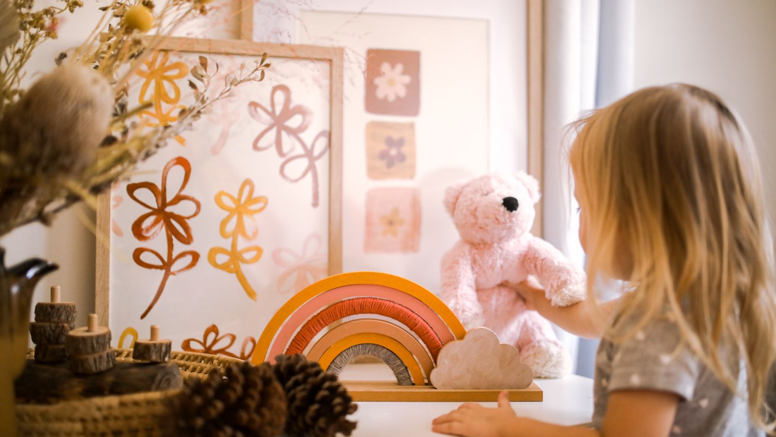child-plays-with-teddy-bear