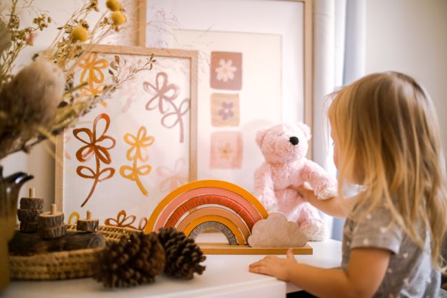 child-plays-with-teddy-bear
