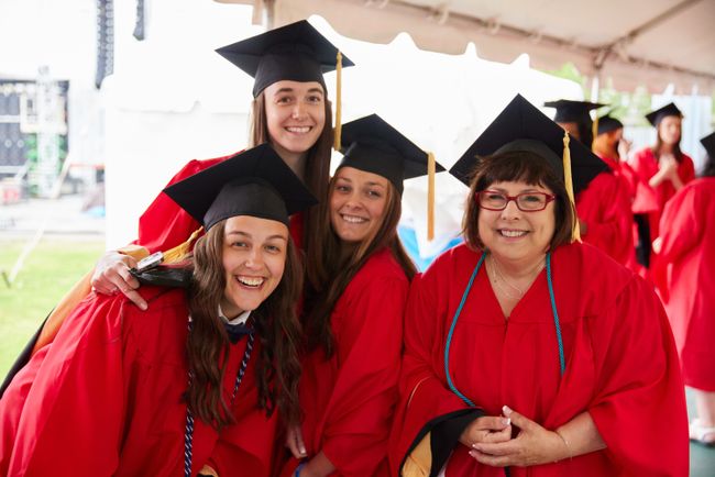 Graduates pose for a photo while standing in line before commencement