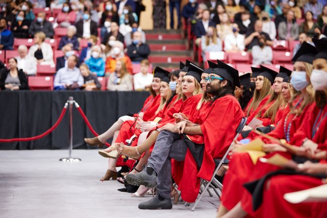 Grads in the front rows watch the second student speaker