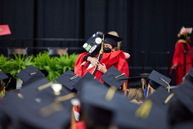 Two grads embrace
