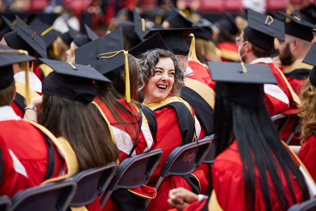 A grad smiles over their shoulder