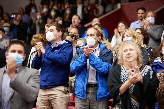 Guests clap from the stands