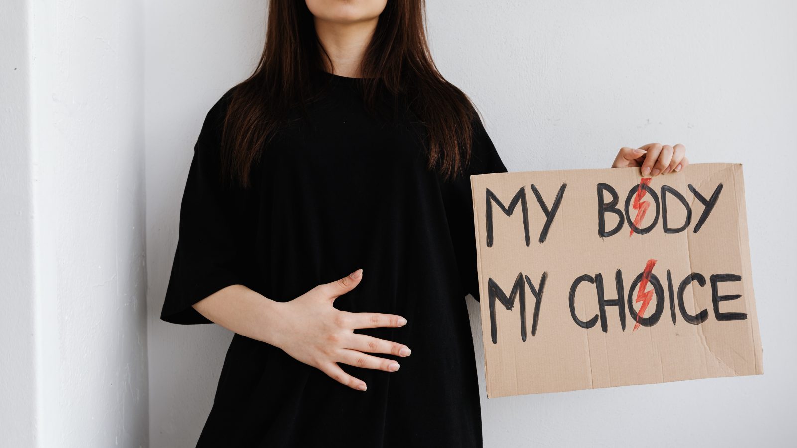 woman holds sign that says "my body, my choice"