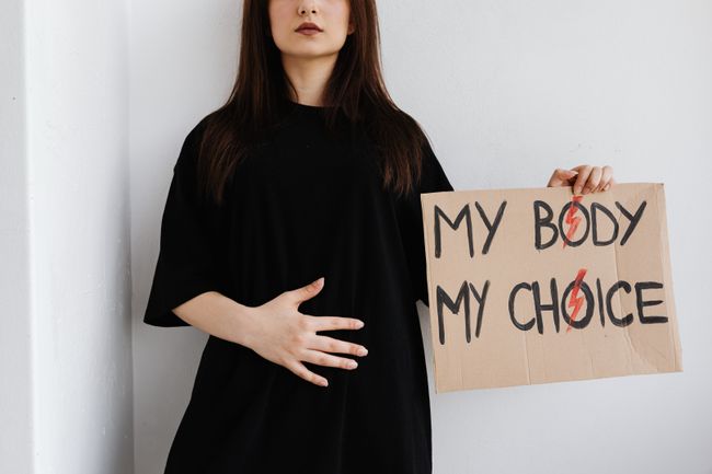 woman holds sign that says "my body, my choice"