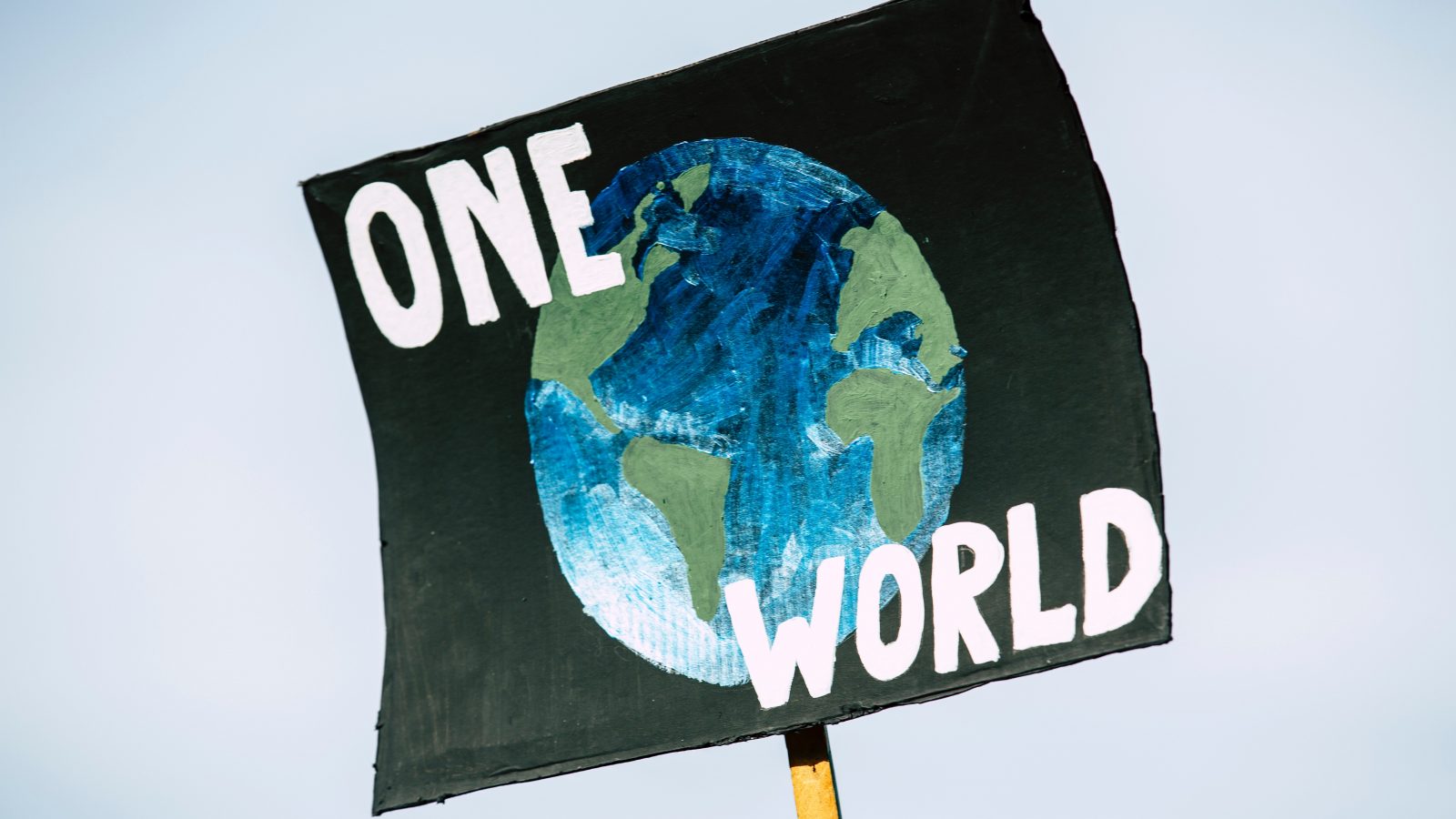 One World climate justice sign