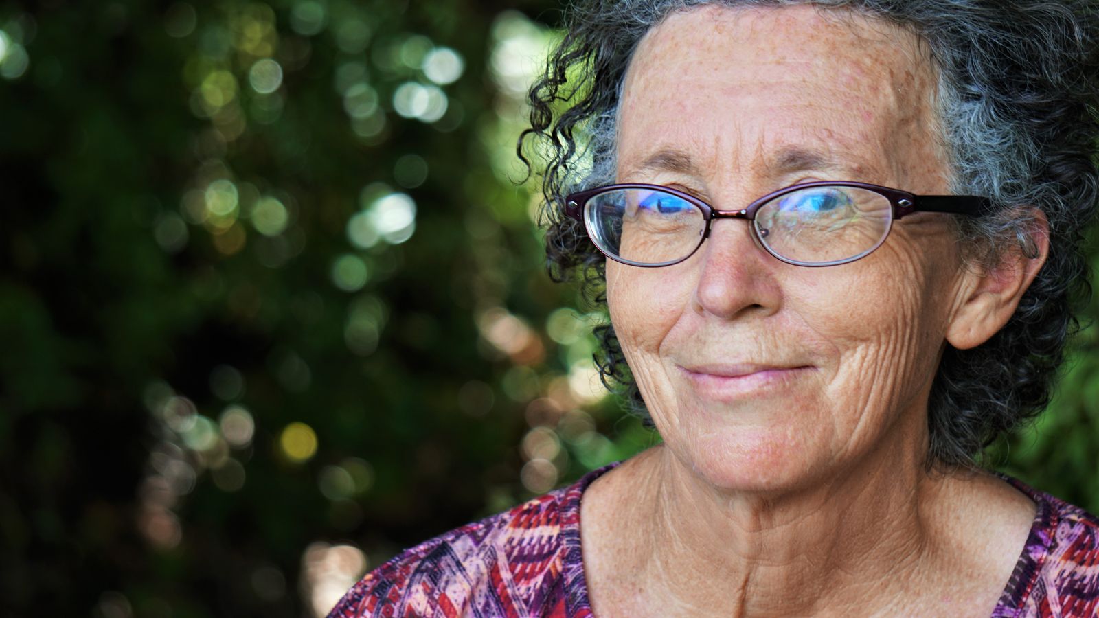 an elderly woman smiling at camera