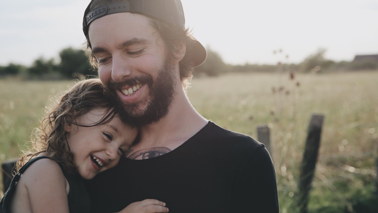 a dad and daughter laughing